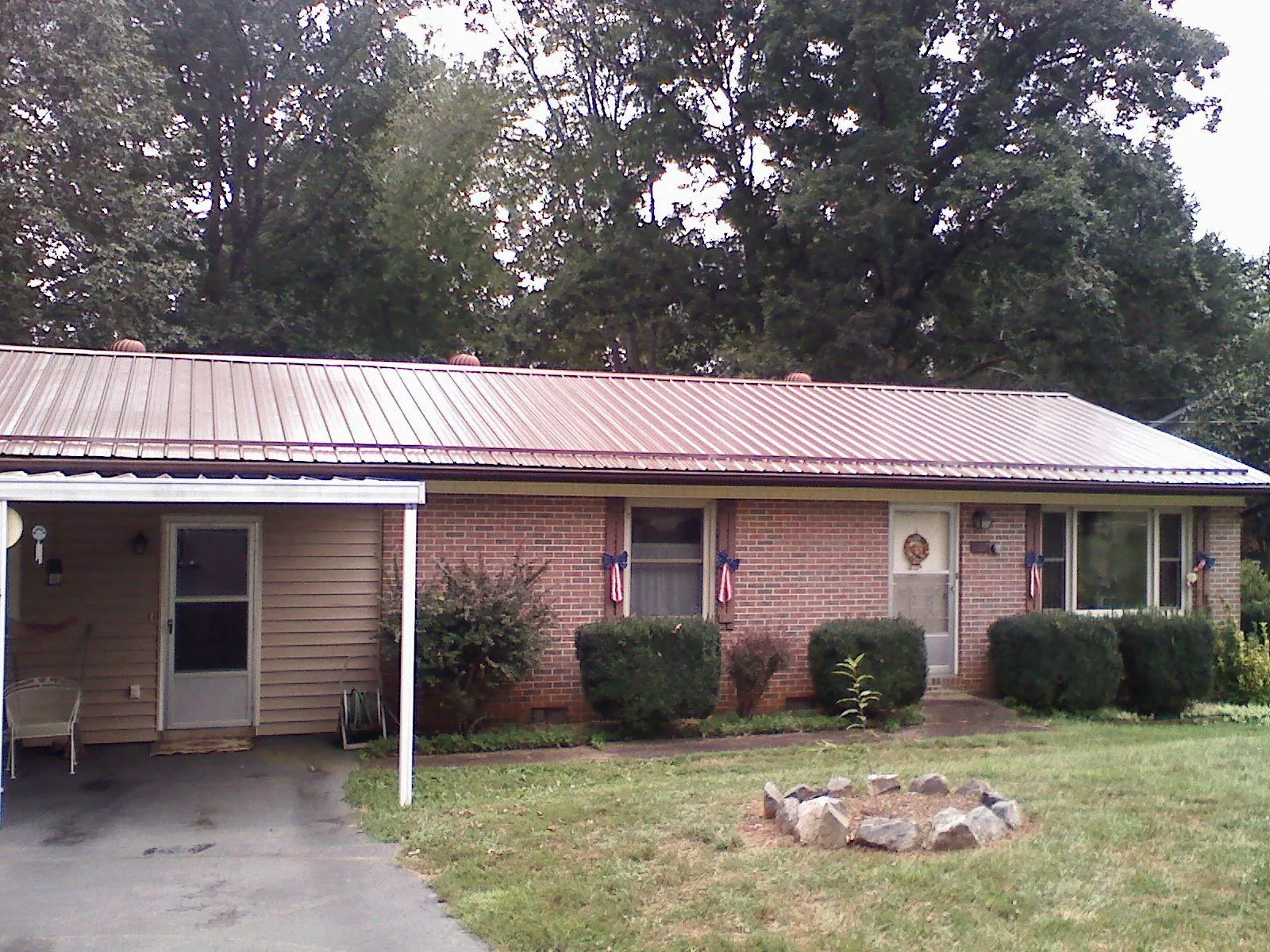 Bronze metal roof and carport on a brick ranch home — Roof Repair work by our crew in Grass Valley
